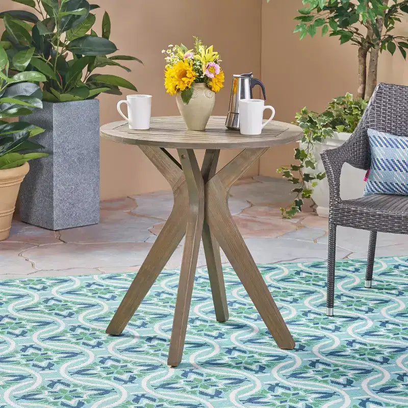 Table de bistrot ronde d'extérieur Brigitte en bois d'acacia avec base croisée GDFStudio