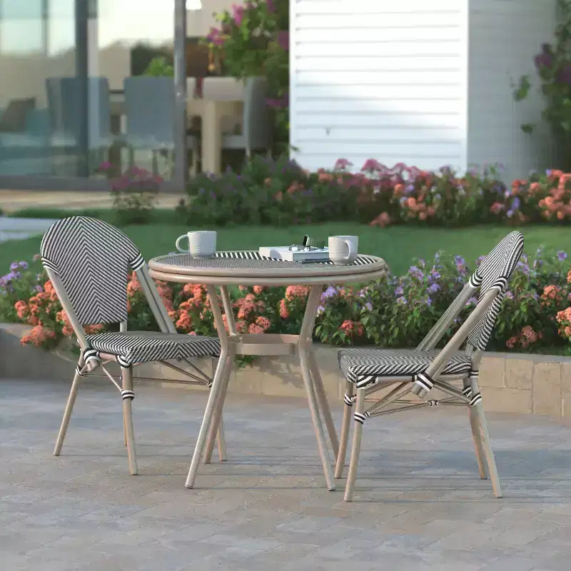 Table de style bistrot Massalia Emma & Oliver, de 80 cm, pour l'intérieur et l'extérieur, avec textilène, plateau en verre et cadre en métal finition bambou