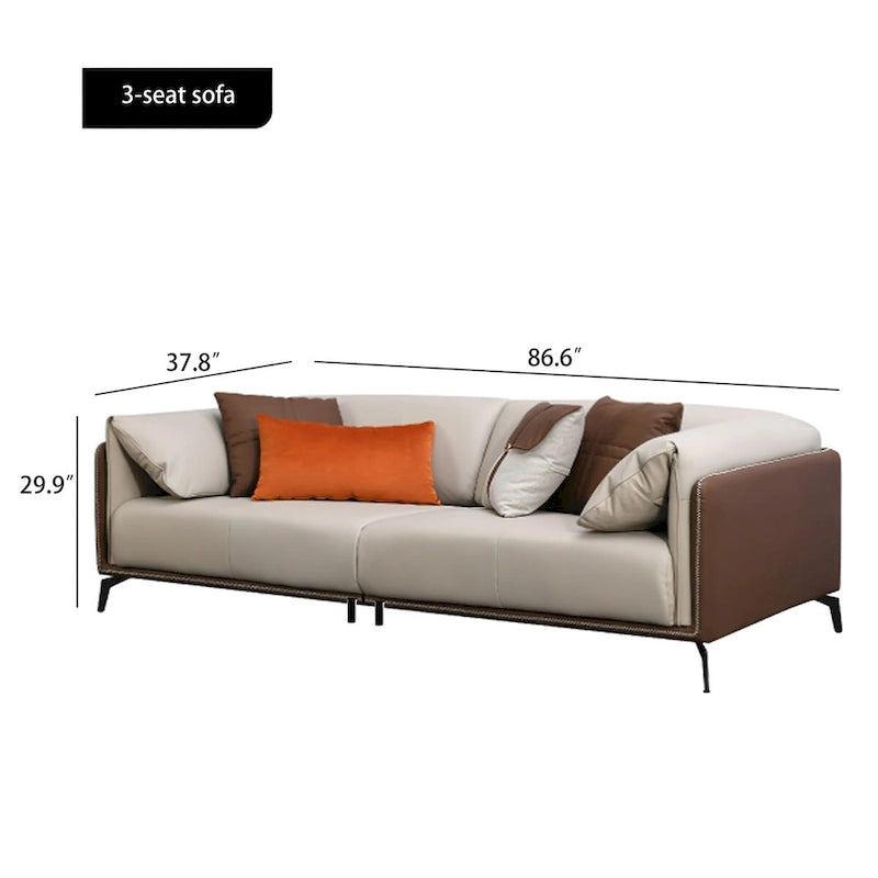 Canapé trois places en similicuir avec accoudoirs hauts et coussins réversibles